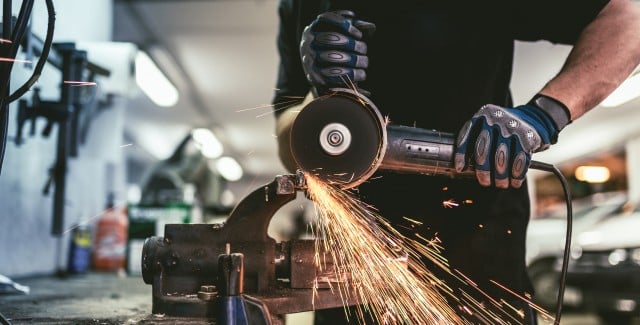 Industry worker with steel angle grinder