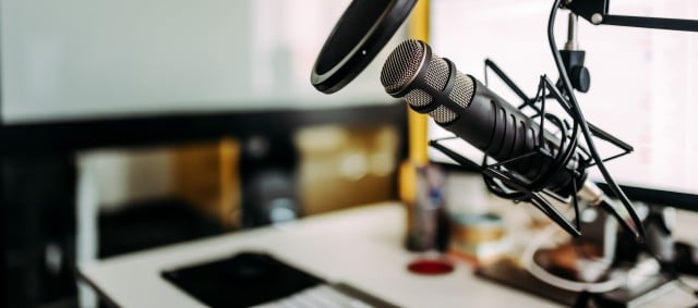 Close-up image of microphone in podcast studio.