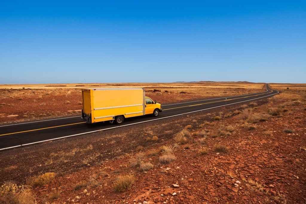 Yellow moving truck in the desert